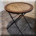 F72. Round folding rattan side table. 